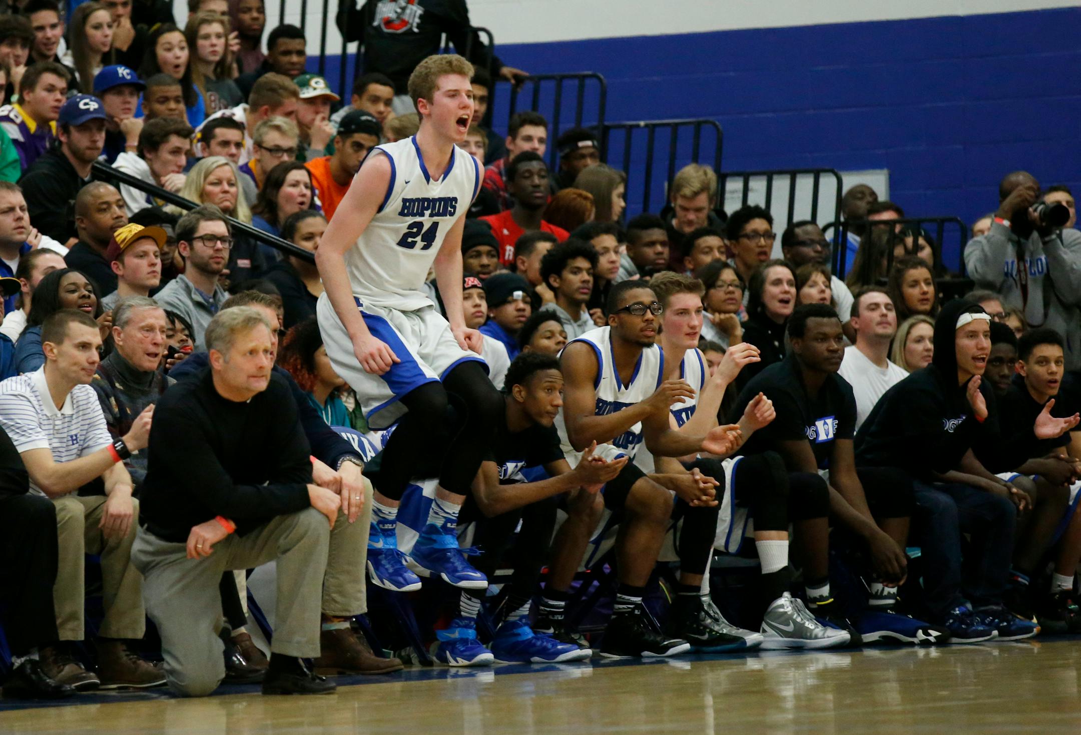 Hopkins center Eric Davies (24) and others on the bench cheer during the Royals' victory over Apple Valley in December. The two teams meet Thursday in the Class 4A state semifinals.