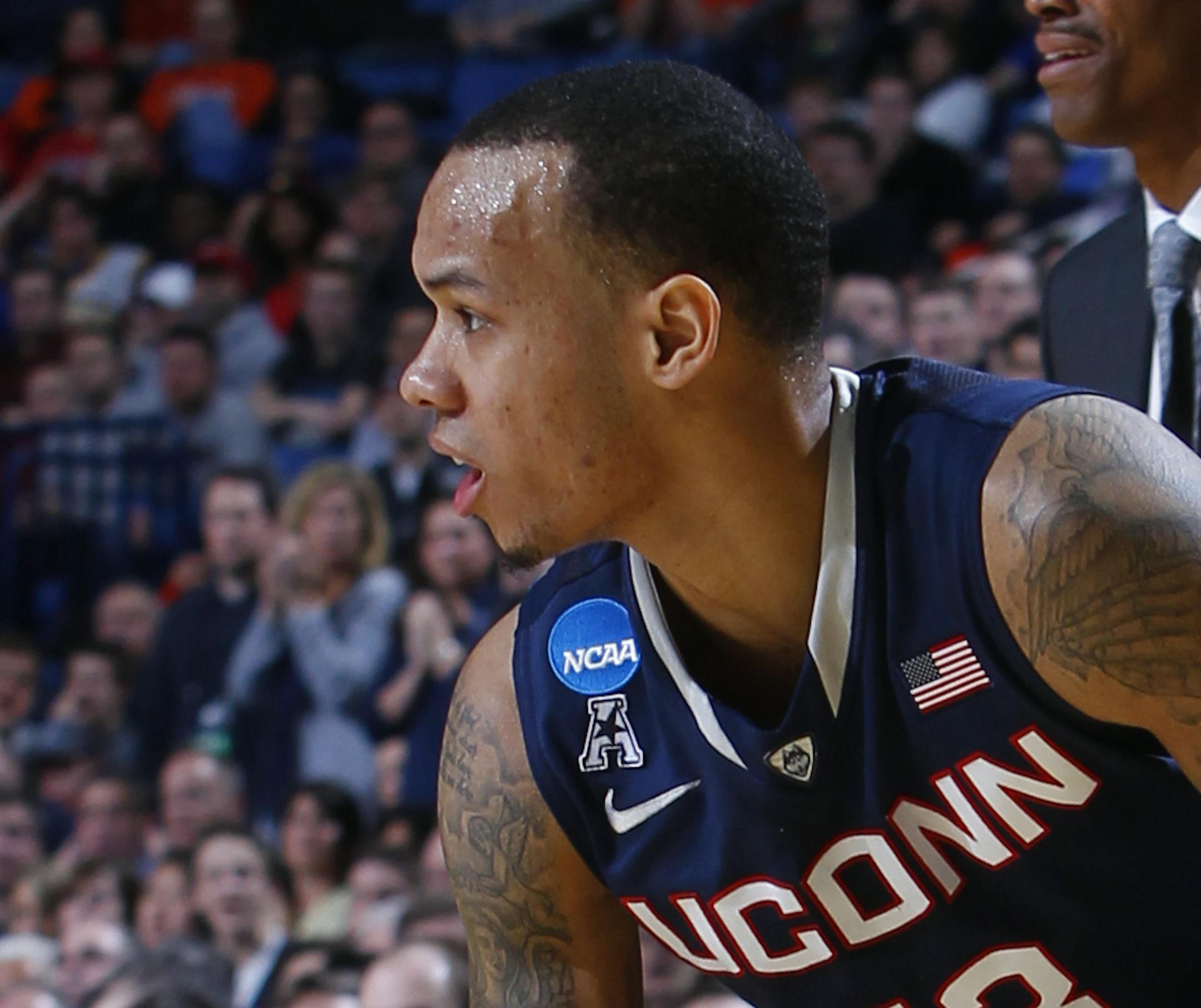 Connecticut guard Shabazz Napier (13) grabs his right leg after he was hurt on a play during the second half of a third-round game against Villanova in the NCAA men's college basketball tournament in Buffalo, N.Y., Saturday, March 22, 2014. Connecticut won the game 77-65. (AP Photo/Bill Wippert)