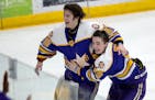 Cretin-Derham Hall goalie Leo Miller (35) and Jake Fisher (18) celebrate at the end of the game.