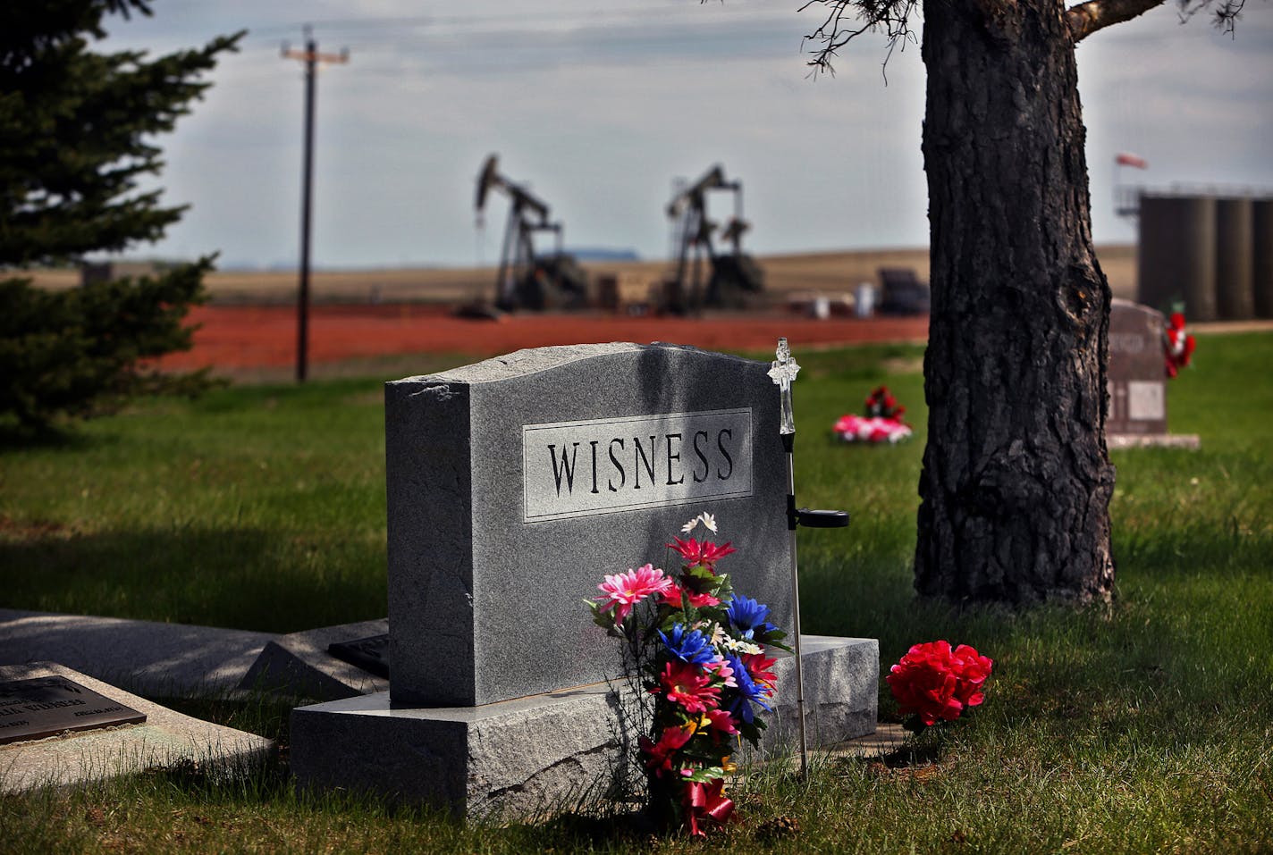 Oil operations surround graves at the Good Hope Cemetery at the First Keene Lutheran Church, which include Wisness family grave sites. ] (JIM GEHRZ/STAR TRIBUNE) / October 23, 2013, Keene, ND &#x201a;&#xc4;&#xec; BACKGROUND INFORMATION- PHOTOS FOR USE IN SECOND PART OF NORTH DAKOTA OIL BOOM PROJECT: Rounding up of cattle and branding calves is a tradition handed down through generations of North Dakotans in the spring each year. Families take turns helping one another carry out the arduous, annu