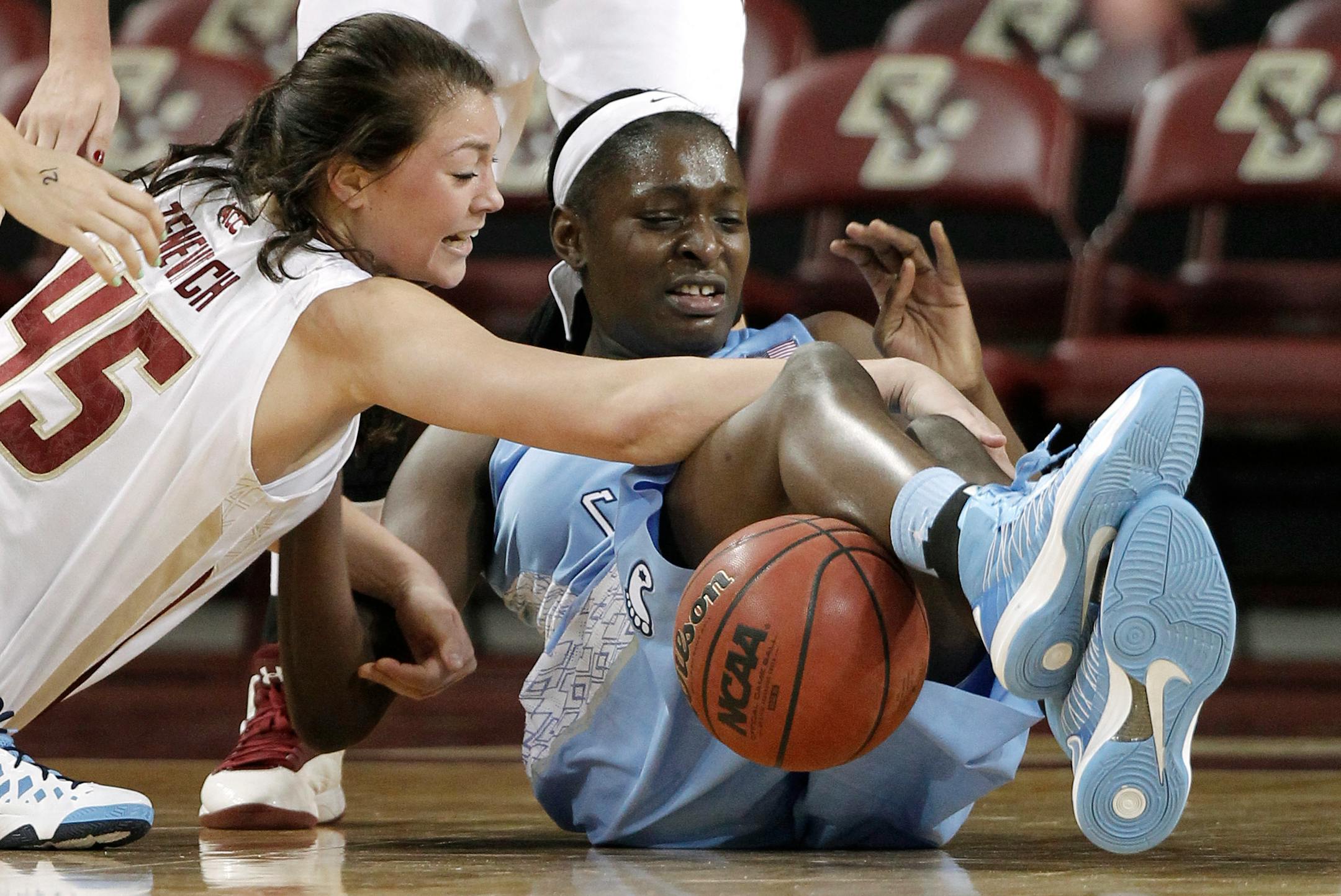 North Carolina's Waltiea Rolle and Boston College's Katie Zenevitch (45) compete for a loose ball during the first half of an NCAA college basketball game in Boston on Thursday, Feb. 7, 2013. (AP Photo/Winslow Townson)