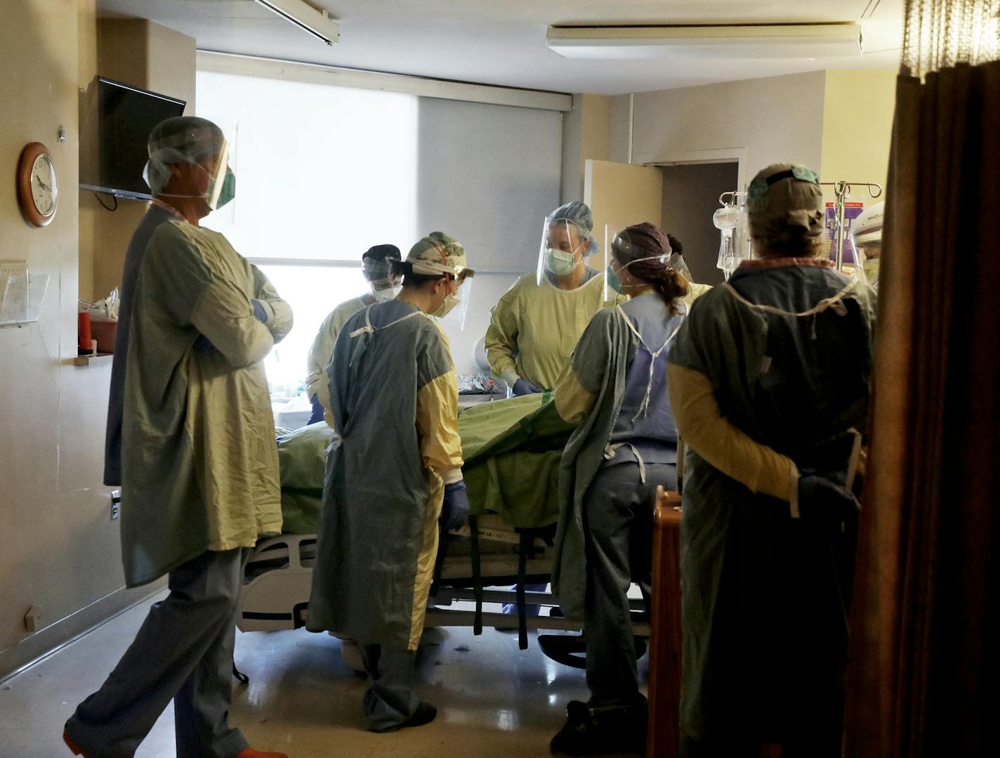 Health care workers get a COVID-19 patient situated after proning the patient, which helps blood flow and breathing, in the fifth-floor ICU at Bethesda Hospital in St. Paul on May 7.