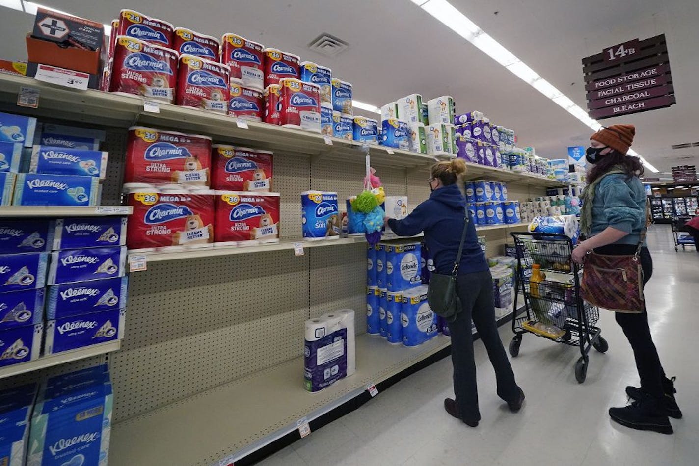 A woman buys toilet paper at a market in Mount Lebanon, Pa, on Tuesday, Nov. 17, 2020.