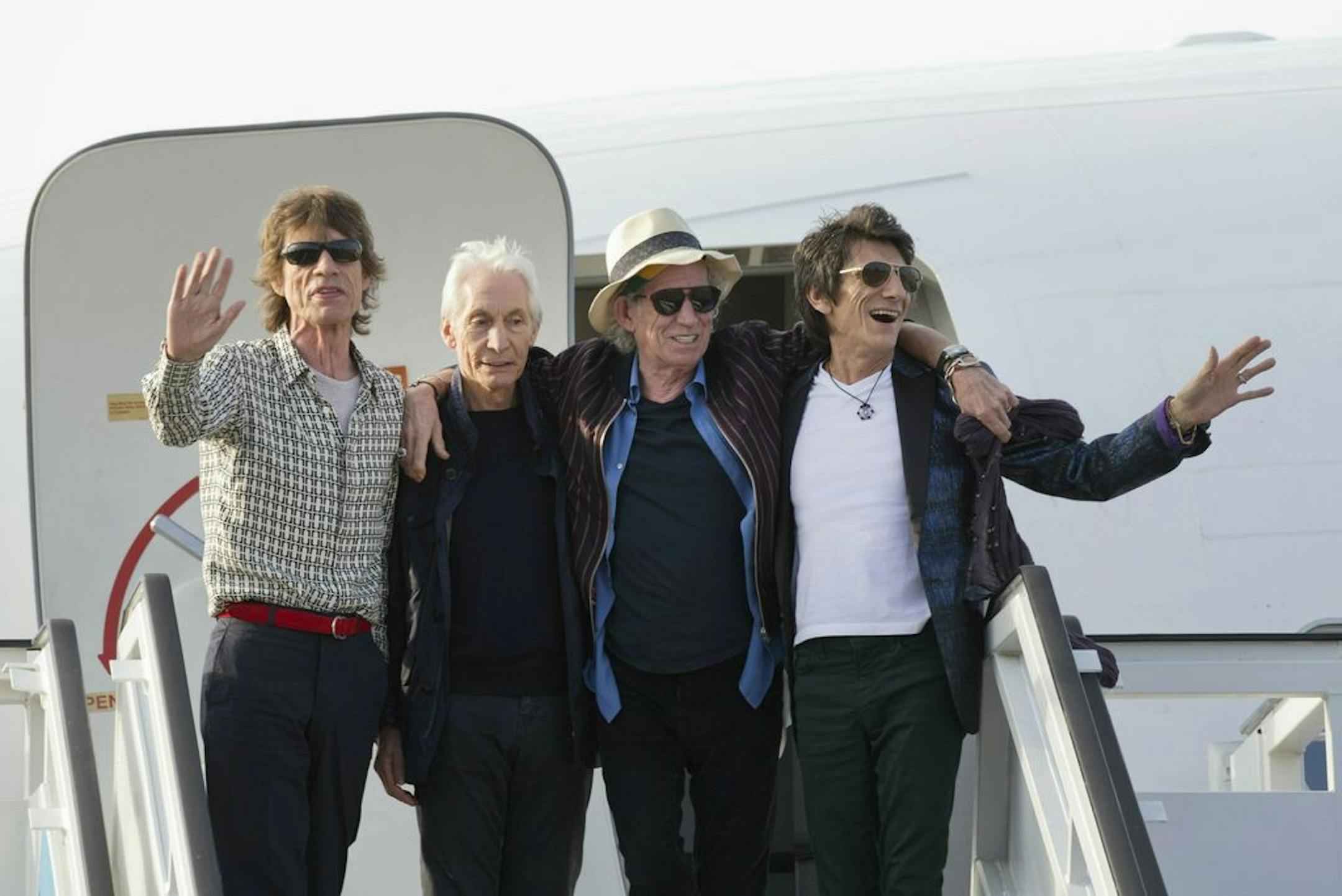 FILE - In this March 24, 2016 file photo, members of The Rolling Stones, from left, Mick Jagger, Charlie Watts, Keith Richards and Ron Wood pose for photos from their plane at Jose Marti international airport in Havana, Cuba. The Rolling Stones are threatening U.S. President Donald Trump with legal action for using their songs at his reelection campaign rallies despite cease-and-desist directives, according to a statement issued by the band Sunday June 28, 2020.