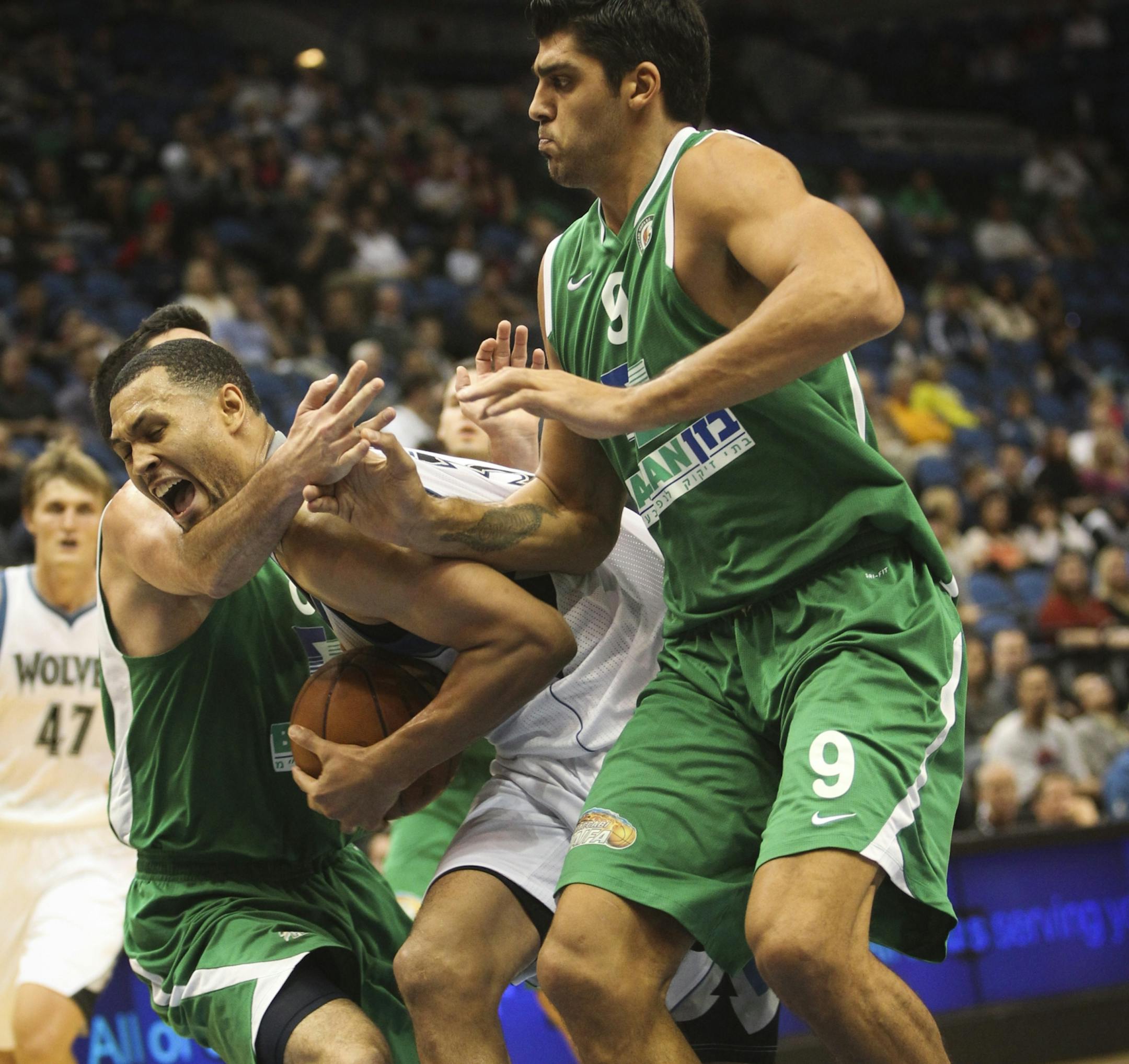 Timberwolves player Brandon Roy broke through Maccabi Haifa players Bryan Cohen and Alex Chubrevich in the second half of a baseball game against Maccabi Haifa on Tuesday, October 16, 2012 at the Target Center in Minneapolis, Minn.