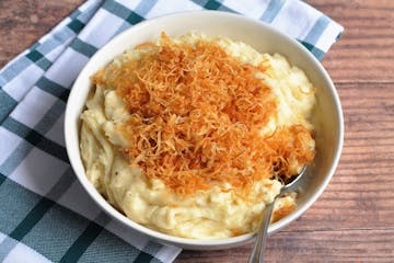 Fried shallots top these cheesy Irish mashed potatoes.