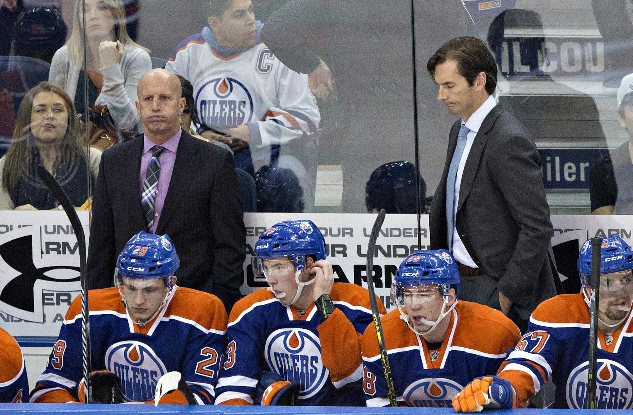 FILE - In this Dec. 1, 2014, file photo, Edmonton Oilers assistant coach Keith Acton, left, and head coach Dallas Eakins , right, react to a shorthanded goal scored by the Arizona Coyotes during the second period of an NHL hockey game in Edmonton, Alberta. Dallas Eakins has been fired as coach of the Edmonton Oilers, who have lost 15 of 16 games and are well on the way to missing the playoffs for the ninth consecutive season. According to reports, general manager Craig MacTavish will coach the t