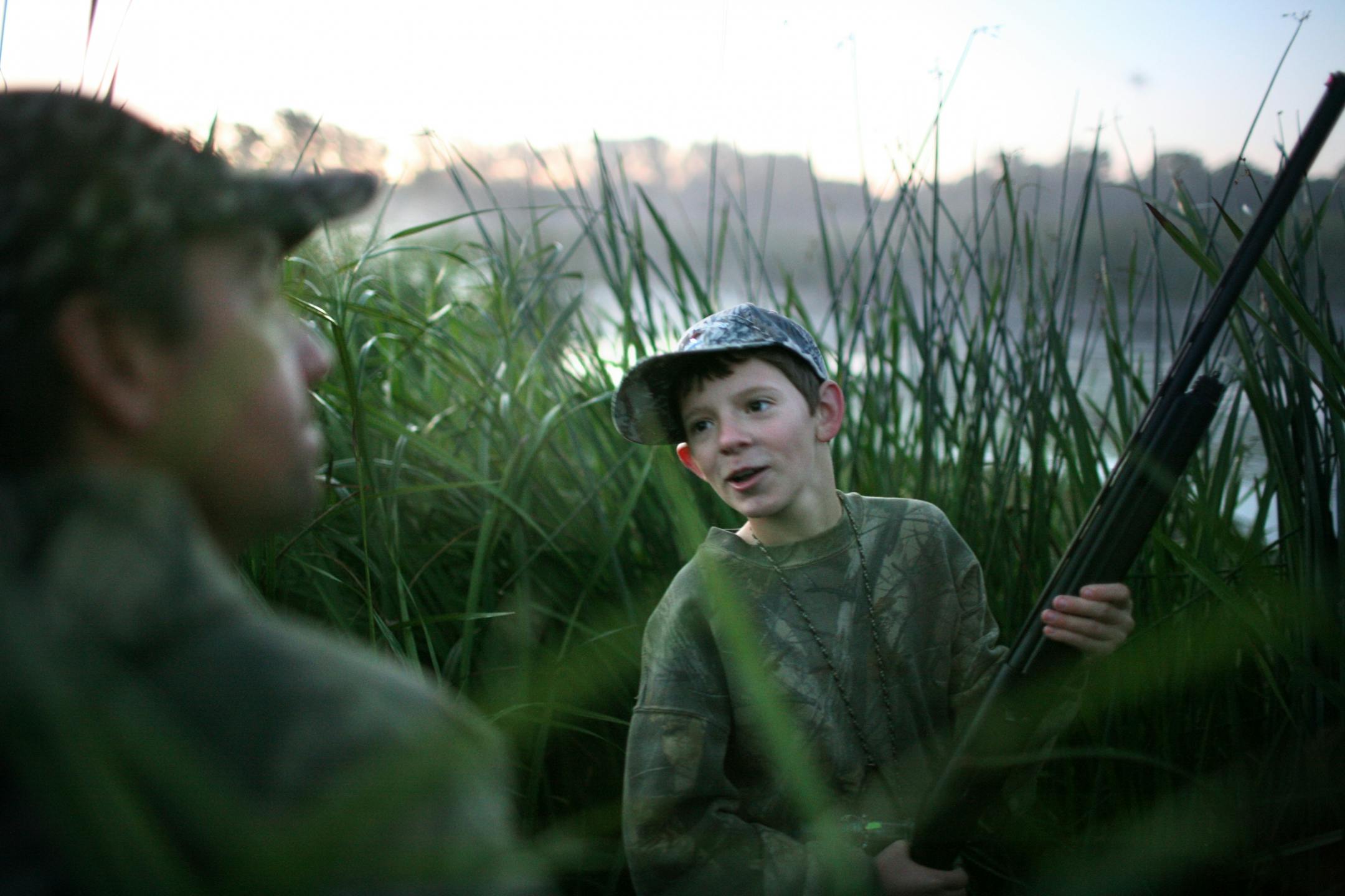 Trevor Lenzen, 13, talks with his dad Brian, his mentor on the hunt, early Saturday morning.