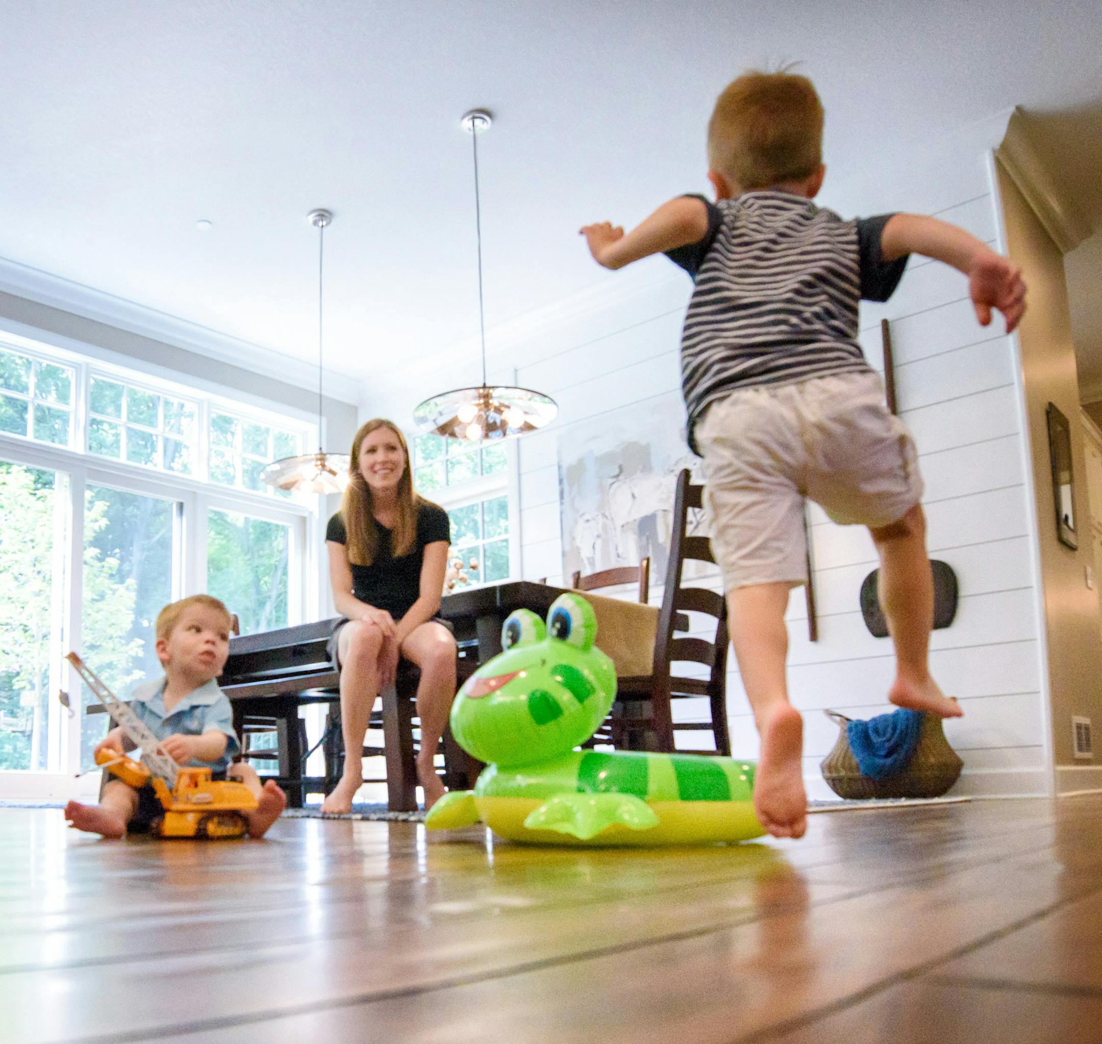 Builder Scott Santanni watched as Jackie's daughter Rachel with her two children play in the kitchen. ] GLEN STUBBE * gstubbe@startribune.com Wednesday, July 13, 2016 266246 Upsizing for grandkids. Empty-nester Jackie Chase built a bigger, kid-friendly house in Mendota Heights as a magnet for her grandkids. EDS, family did not wants kids names used.