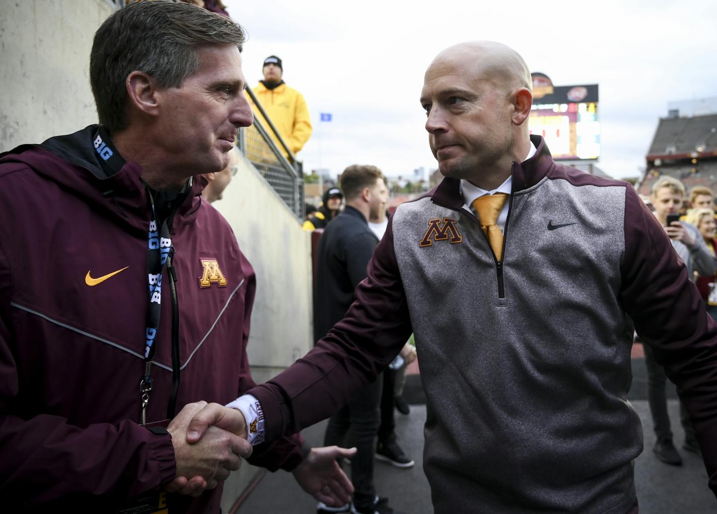 Gophers head coach P.J. Fleck shook hands with University of Minnesota Athletic Director Mark Coyle following his team's 40-17 win against Illinois, bringing the Gophers' 2019 team record to 5-0.