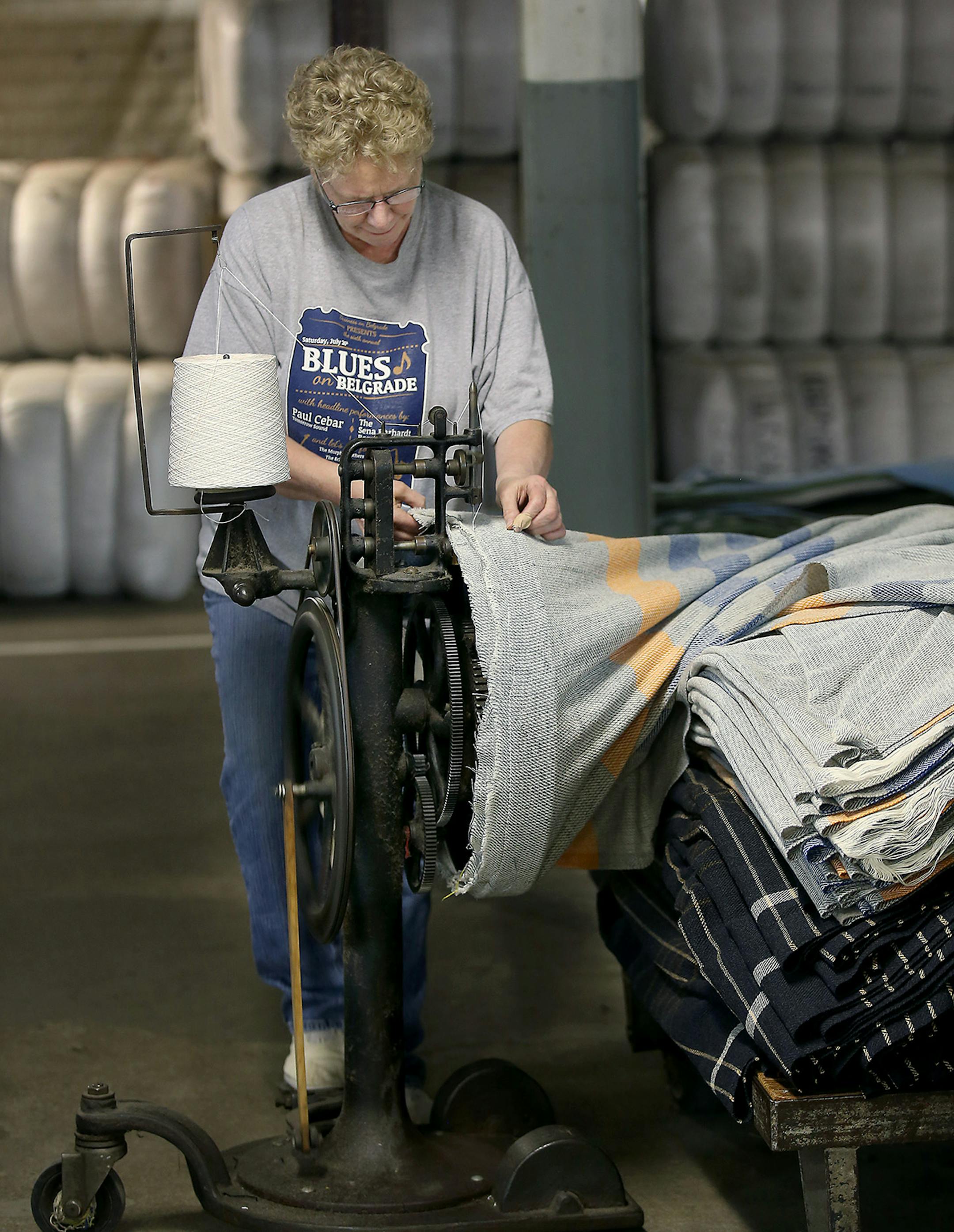 Jody VanDellen worked with an antique sewing machine at the Faribault Woolen Mill, Thursday, August 6, 2015 in Faribault, MN. The mill is celebrating its 150th anniversary. It started during the Civil War. ] (ELIZABETH FLORES/STAR TRIBUNE) ELIZABETH FLORES • eflores@startribune.com