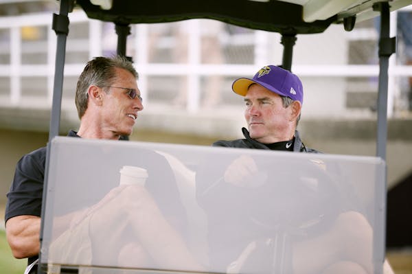 Vikings GM Rick Spielman left talked with head coach Mike Zimmer during NFL camp at Minnesota State University , Mankato Monday July 28, 2014 in Manka