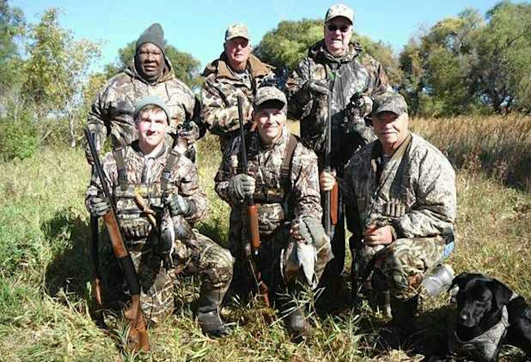 Members and friends of the Christina Hunt Club. Back row, from left to right: Fred Harris, Roger Smith, Merrill Johnson. Front row: Andy Hoffmann, Mike Gahlon, Tim Hoffmann and Tim's black lab Bob.