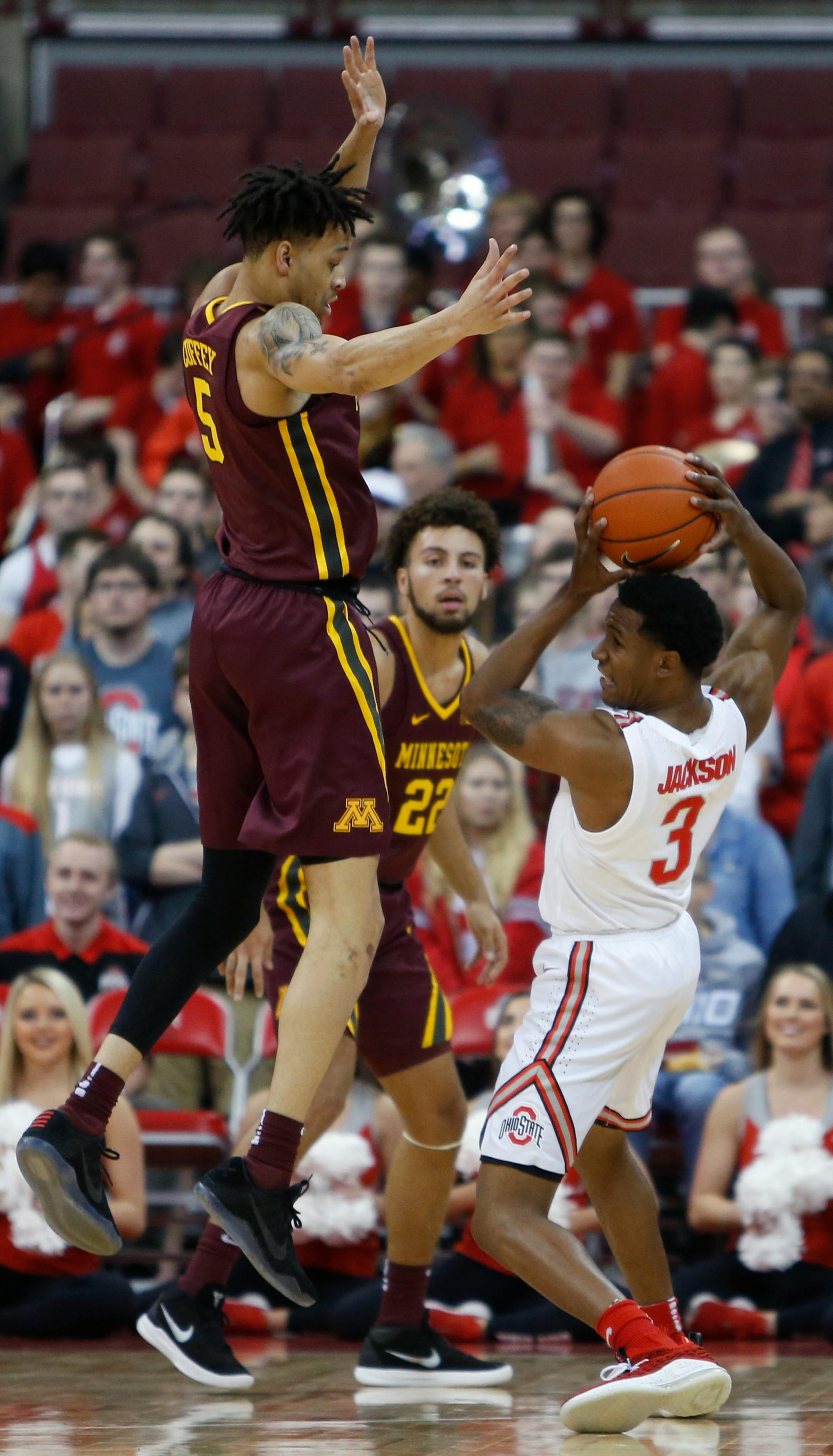 Minnesota's Amir Coffey, left, and Gabe Kalscheur, center, trap Ohio State's C.J. Jackson during the first half of an NCAA college basketball game Sunday, Dec. 2, 2018, in Columbus, Ohio. (AP Photo/Jay LaPrete)