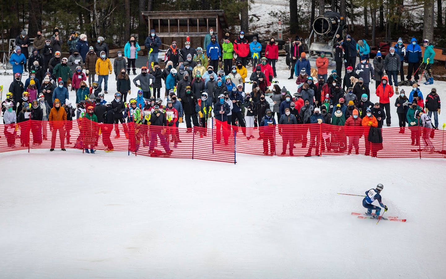 A large crowd of people, most of them family members of racers, gathered by the finish line to watch the MSHSL Boys and Girls Alpine Skiing State Meet on Wednesday in Biwabik, Minn.. ]