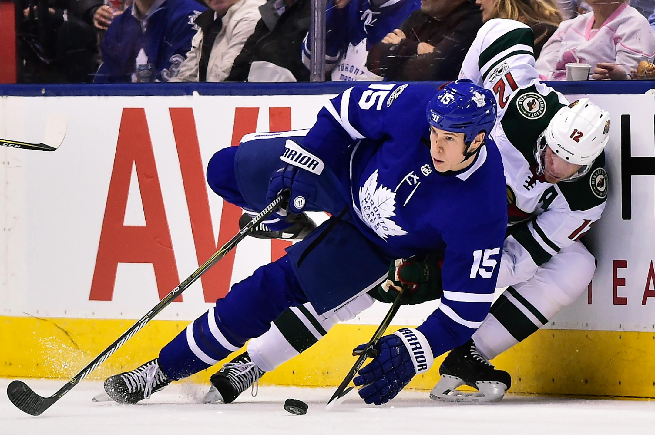 Toronto Maple Leafs left wing Matt Martin (15) and Minnesota Wild center Eric Staal (12) compete along the boards during the second period of an NHL hockey game Wednesday, Nov. 8, 2017, in Toronto. (Frank Gunn/The Canadian Press via AP)