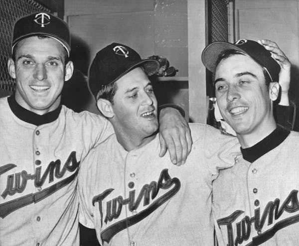 Twins outfielder Bob Allison (left), pitcher Pedro Ramos and third baseman Reno Bertoia celebrate in the locker room after defeating the New York Yank
