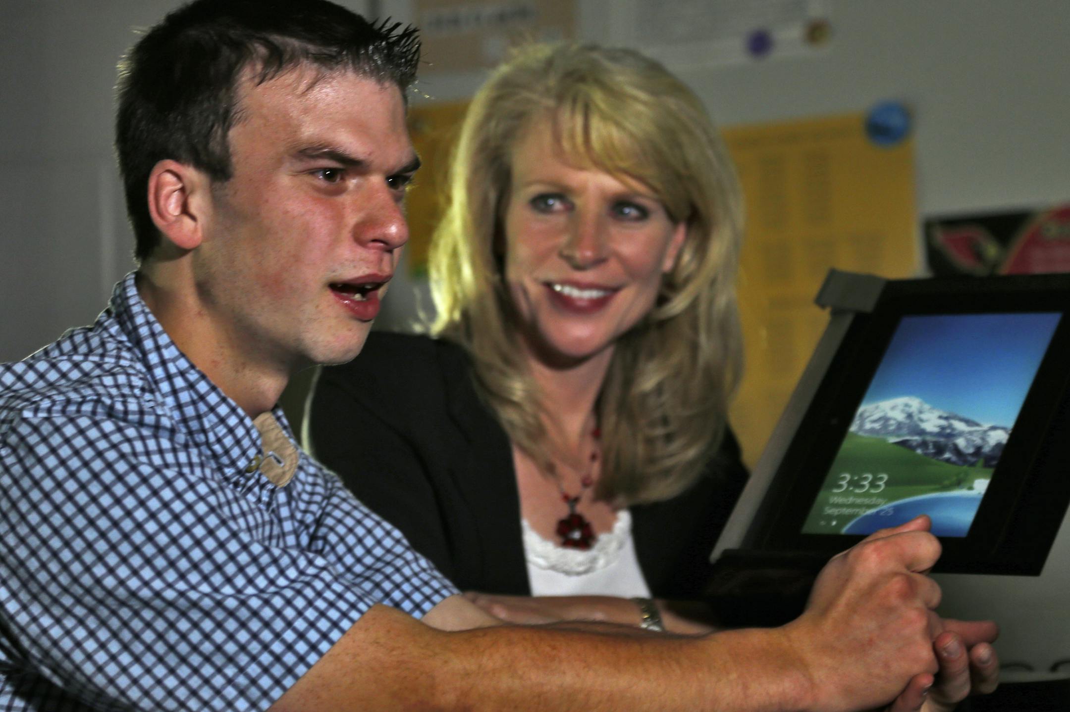 Anoka High School special education student Jeff Shogren wrote an essay about his teacher Karen Flaherty that won them each a Dell XPS tablet. Shogren, left, and Flaherty with one of the tablets won in the contest. (MARLIN LEVISON/STARTRIBUNE(mlevison@startribune.com)