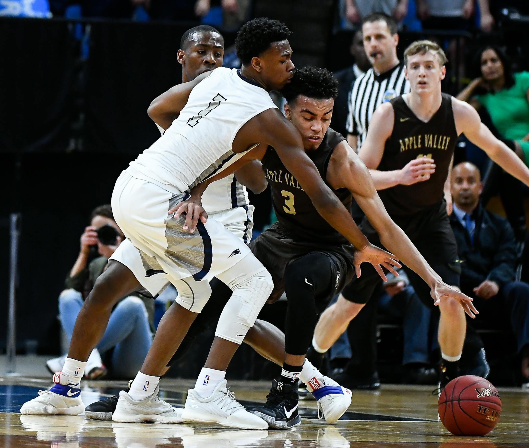 Champlin Park's Marcus Hill (1) was called for a foul against Apple Valley guard Tre Jones