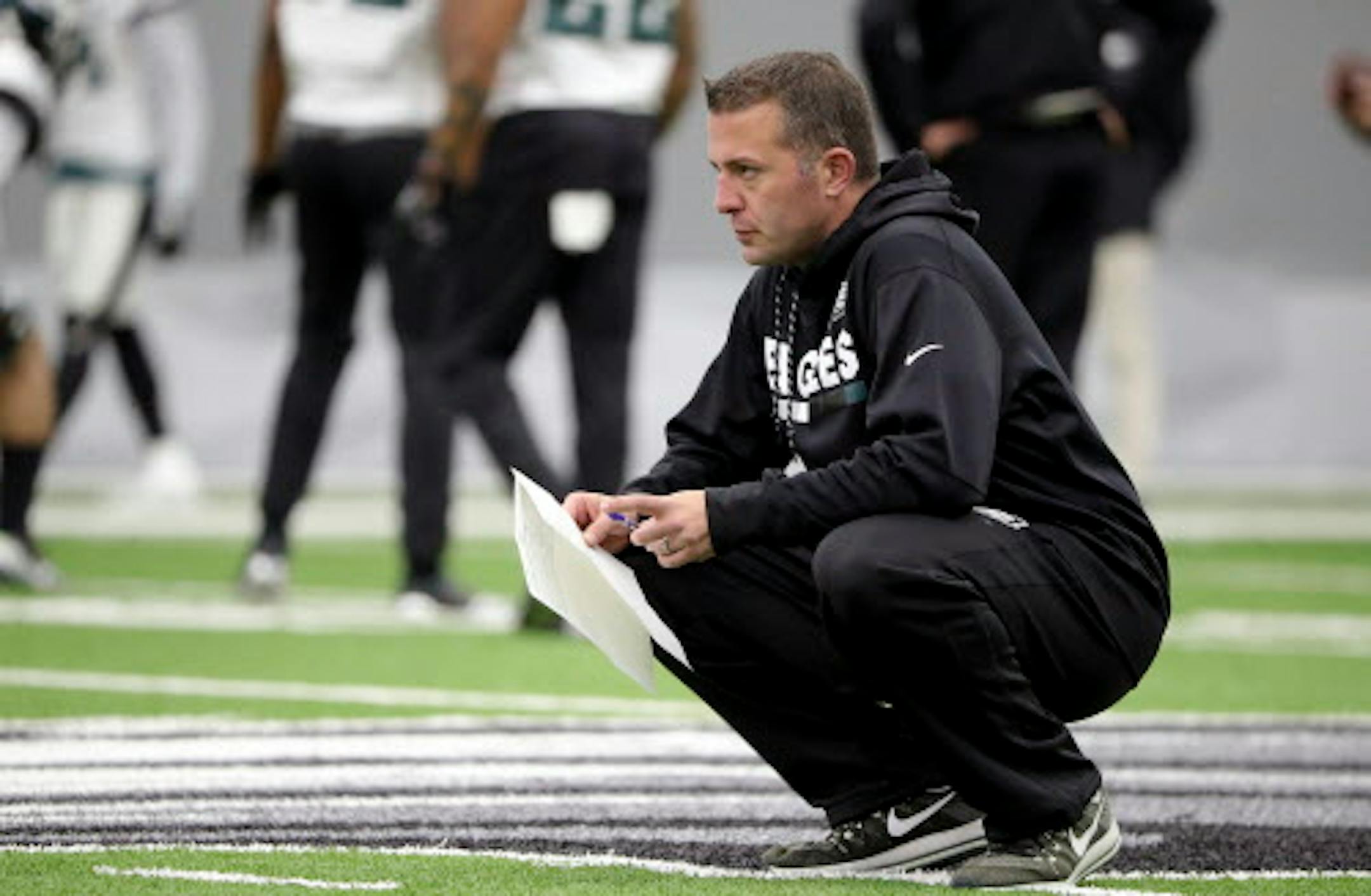 In this Jan. 3, 2018, photo, Philadelphia Eagles quarterbacks coach John DeFilippo watches the team practice in Philadelphia, Pa. The Minnesota Vikings have hired Philadelphia Eagles quarterbacks coach John DeFilippo as their offensive coordinator. DeFilippo replaces Pat Shurmur, who became head coach of the New York Giants. The deal was done Friday, Feb. 9, 2018. (David Maialetti/The Philadelphia Inquirer via AP)