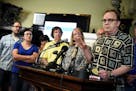 Jamie Heutmaker, far right, a victim of clergy sexual abuse, addresses media alongside other victims and family members during a press conference deta