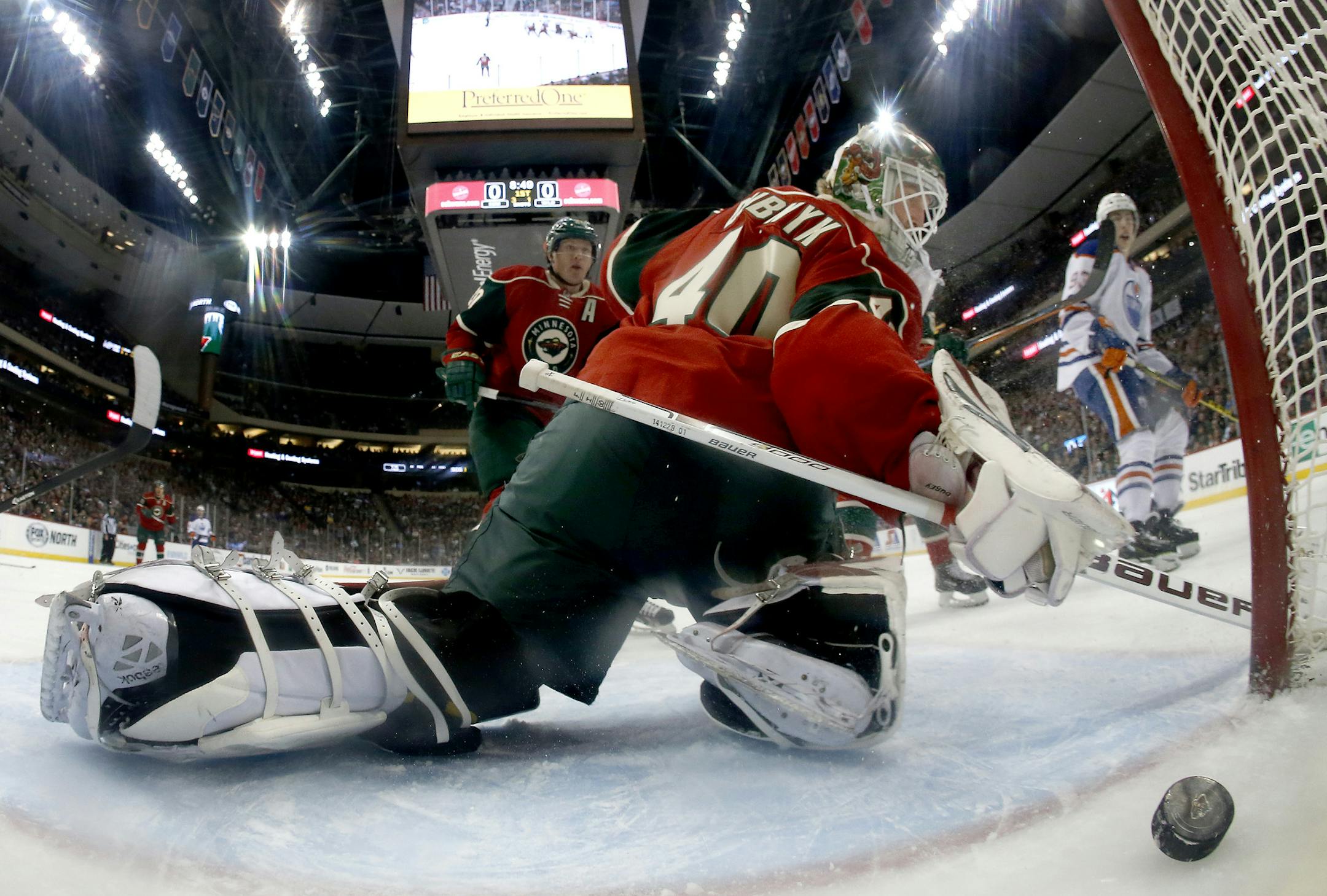 Benoit Pouliot (67) got the puck past Minnesota Wild goalie Devon Dubnyk for a goal in the first period.