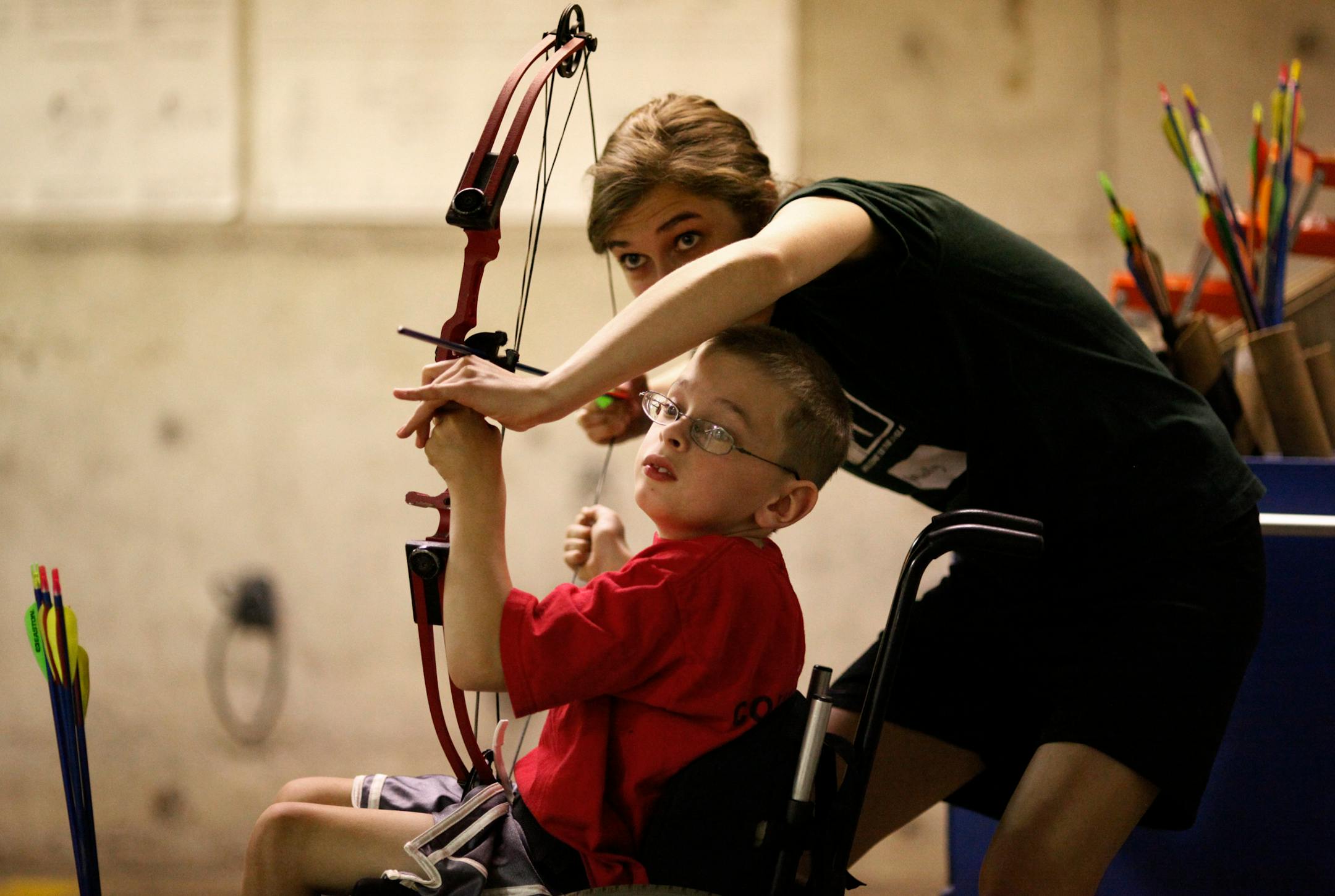 Molly Adams helped Hayden Audette sight in his bow.