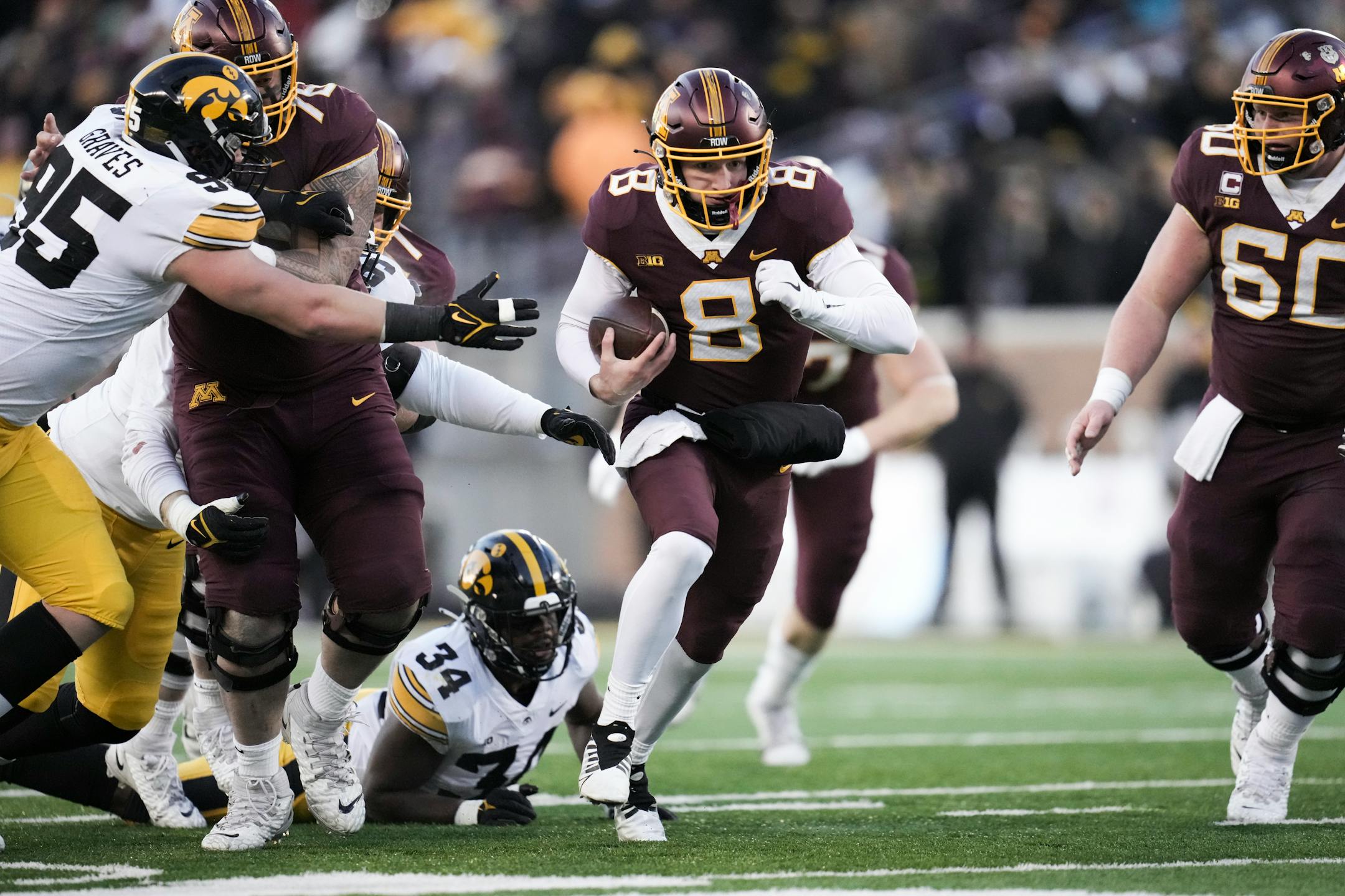 Minnesota Gophers quarterback Athan Kaliakmanis (8) ran the ball against the Iowa Hawkeyes in the second quarter.