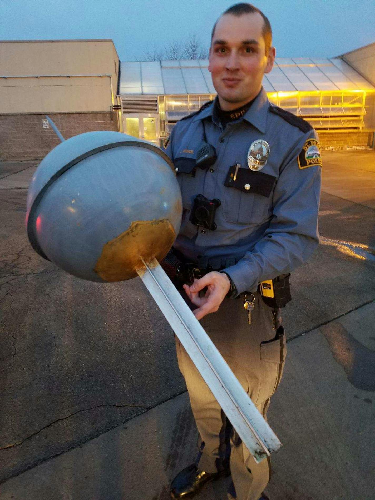 A St. Paul Police office holding the finial.