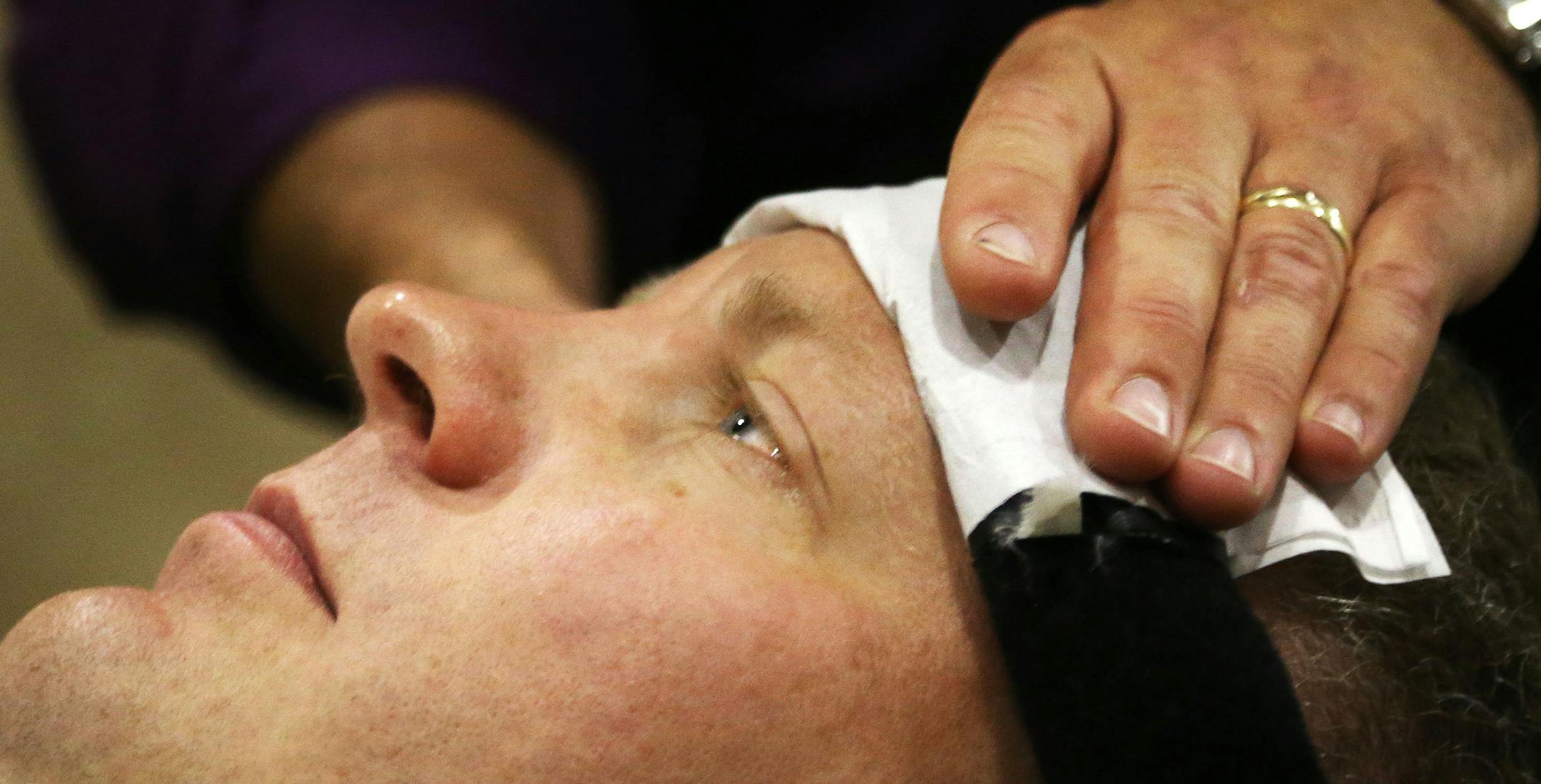 Neil Krenz, Lino Lakes, a retired U.S. Army National Guard member with abnormal curvature of the spine as well as a degenerative disc, gets treatment from chiropractor Sheldon Osvold through Doug Huesby's non-profit, PainFree Patriots inside a trailer, mobile clinic in the Living Word Christian Center parking lot Tuesday, July 28, 2015, in Brooklyn Park, MN. Krenz, who served for 12 years, including a tour in Iraq in 2005, said the treatment he is receiving has greatly improved his quality of li