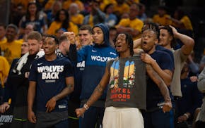 The Wolves bench reacts to an Anthony Edwards dunk late in the fourth quarter Saturday.