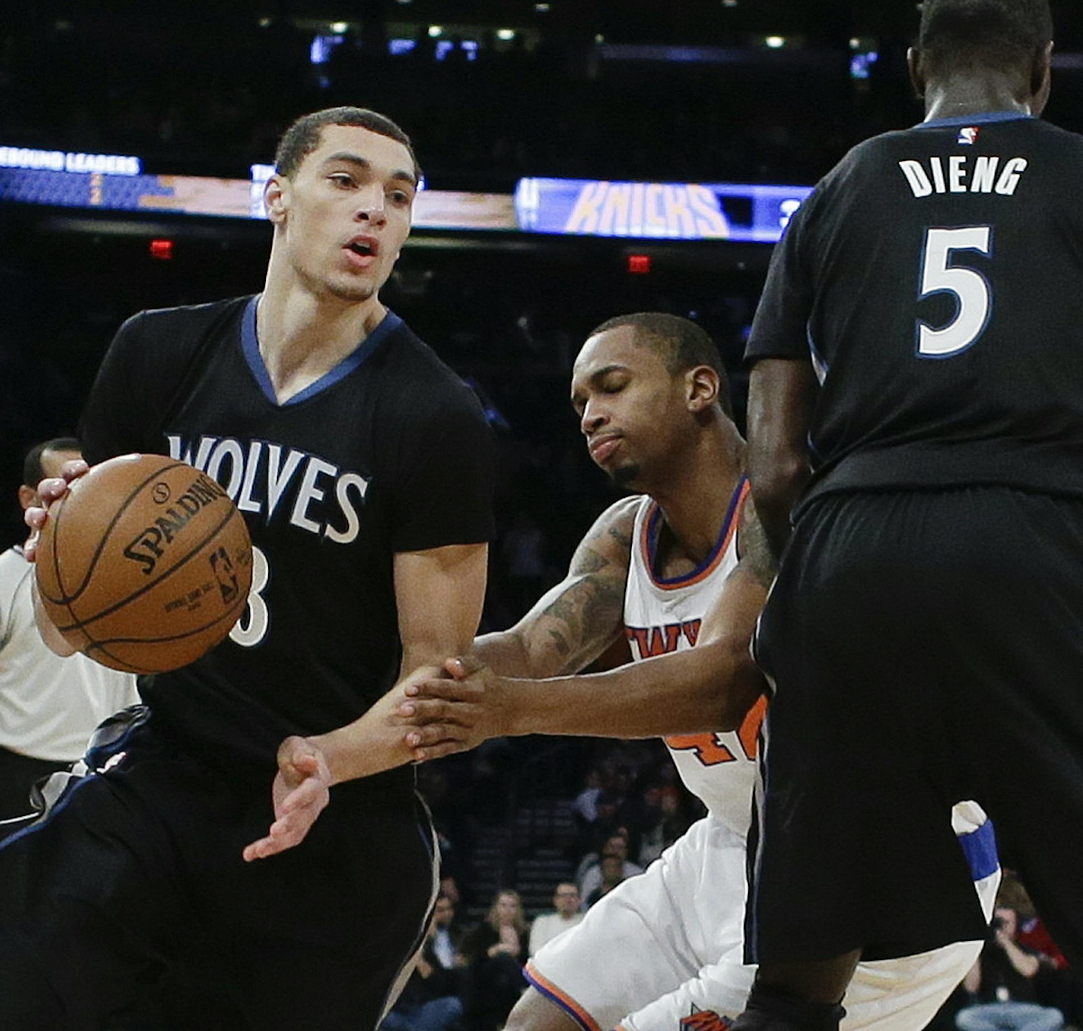 Minnesota Timberwolves' Zach LaVine (8) uses a pick set by teammate Gorgui Dieng (5) as New York Knicks' Lance Thomas (42) chases him during the first half of an NBA basketball game Thursday, March 19, 2015, in New York. (AP Photo/Frank Franklin II)
