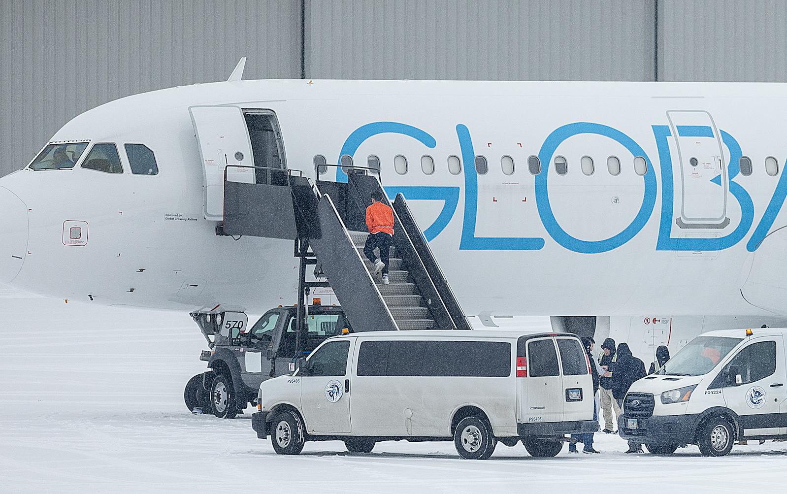 A detainee boards a deportation flight on GlobalX Air at Minneapolis-St. Paul International Airport on Friday, Dec. 5.