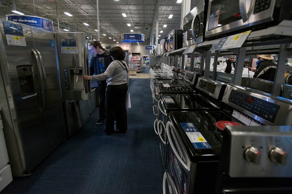Shoppers view a refrigerator at a Best Buy Co. store in San Francisco, California, U.S. on Wednesday, Jan. 30, 2013. Consumer spending in the U.S. cli