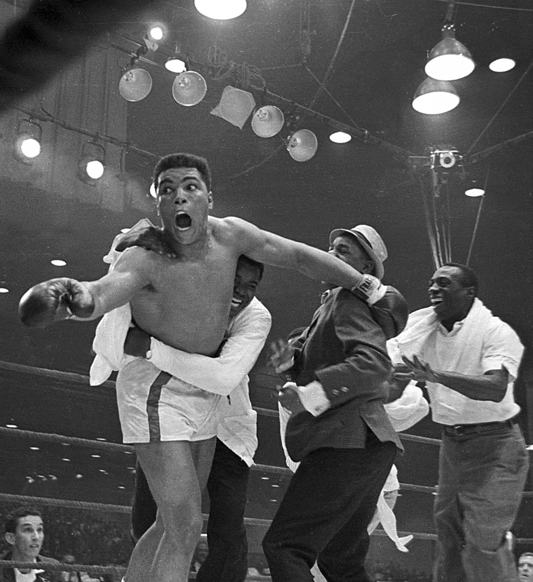 Muhammad Ali (Cassius Clay), boxer, historical photo ---------- Cassius Clay's handlers hold him back as he reacts after he is announced the new heavyweight champion of the world on a seventh round TKO against Sonny Liston in Miami Beach, Fla., on Feb. 25, 1964. It will be 40 years ago Wednesday, Feb. 25, 2004 that Ali won the heavyweight title. The once brash, mouthy young champion now trembles with age and disease and talks sparingly in whispers. But the memories are fresh for Gene Kilroy,who