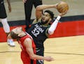 Timberwolves center Karl-Anthony Towns is blocked by Rockets forward Kelly Olynyk during the first quarter