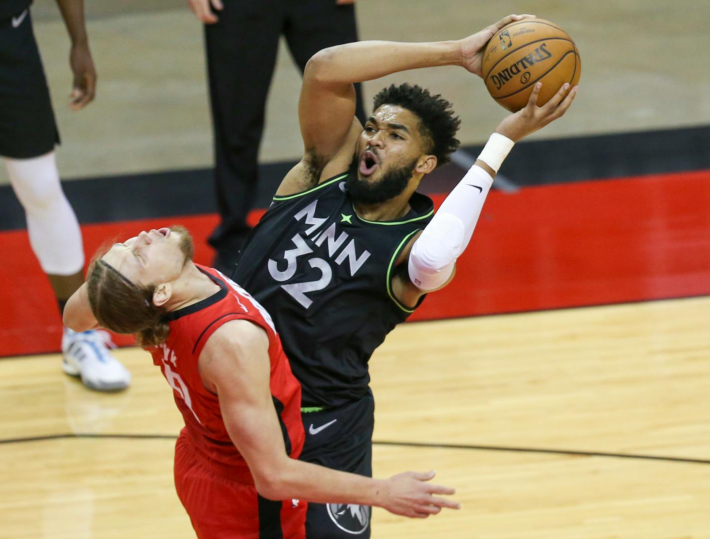 Timberwolves center Karl-Anthony Towns is blocked by Rockets forward Kelly Olynyk during the first quarter