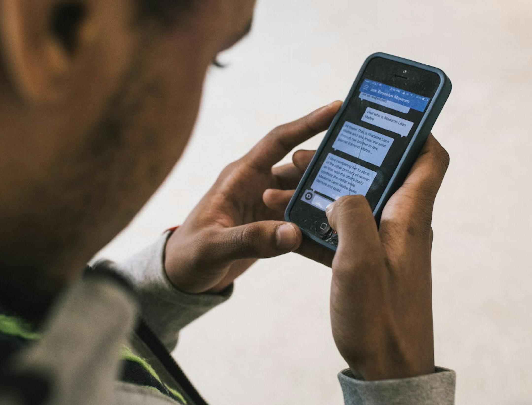 Juwan Stallings uses a smartphone app to ask a staffer about a Henri Fantin-Latour portrait hanging at the Brooklyn Museum in New York, April 23, 2016. Instead of the common audio guide and map, the Brooklyn Museumís app offers patrons only an interface to chat with staffers. Visitors are tentative at first, but quickly get into it ó the average user now sends 13 messages per visit. (Christopher Gregory/The New York Times)