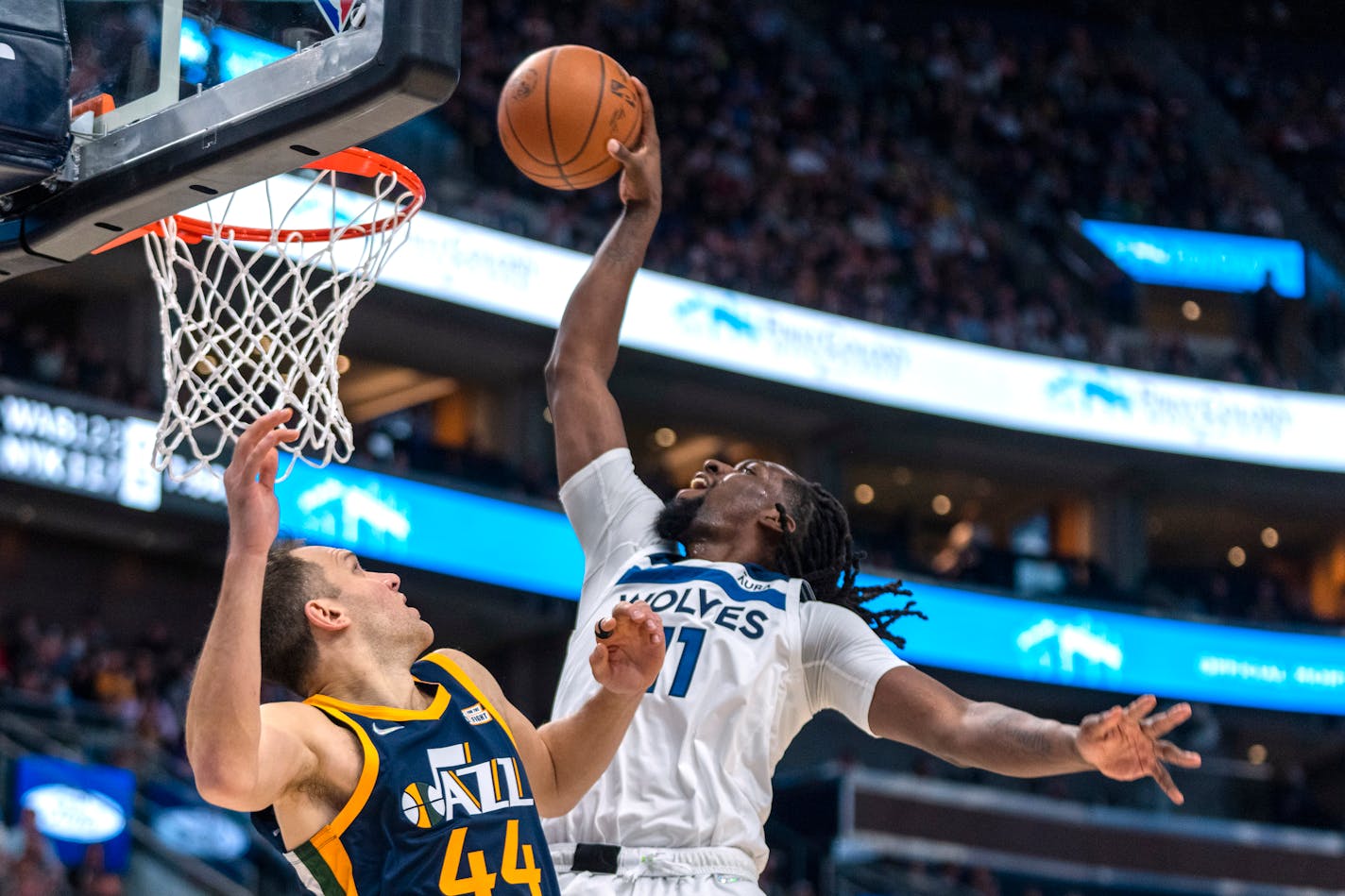 Minnesota Timberwolves center Naz Reid (11) dunks as Utah Jazz forward Bojan Bogdanovic (44) defends during the first half of an NBA basketball game Thursday, Dec. 23, 2021, in Salt Lake City. (AP Photo/)