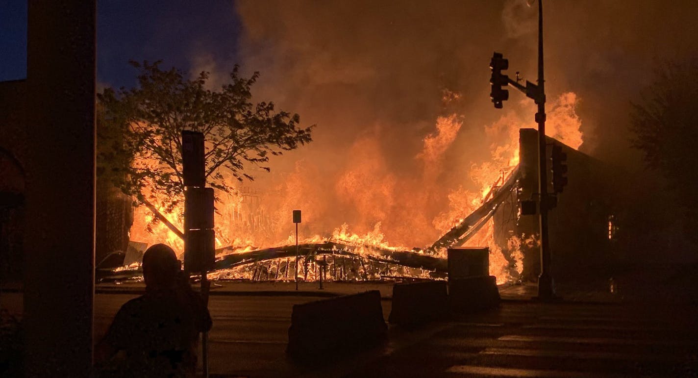 A fire engulfs the Max It Pawn shop on Lake Street and 28th Street on May 28, 2020.