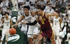 Michigan State Spartans guard A.J. Hoggard (11) steals the ball from Minnesota Golden Gophers guard Payton Willis (0) during first half action Wednesd