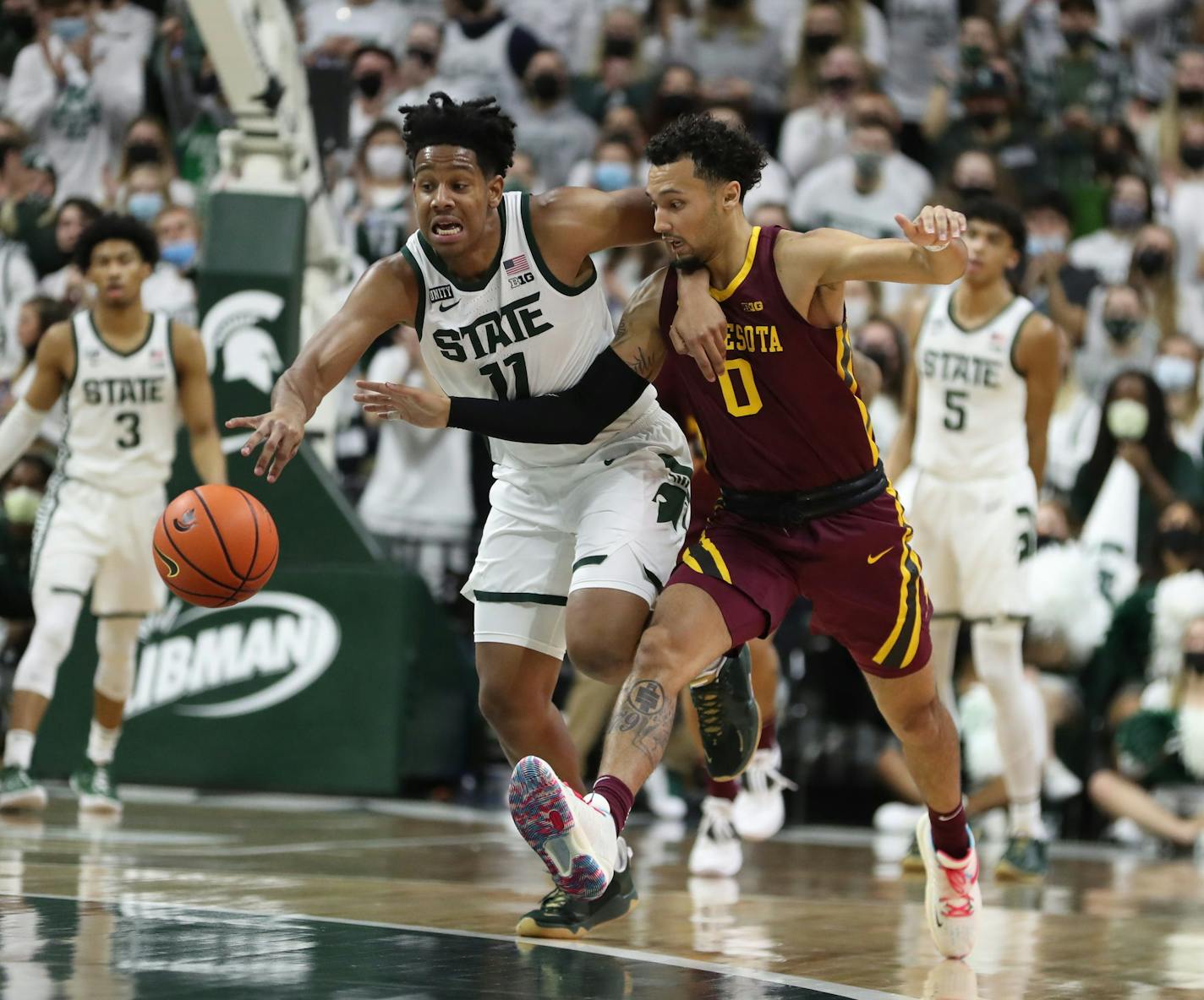 Michigan State Spartans guard A.J. Hoggard (11) steals the ball from Minnesota Golden Gophers guard Payton Willis (0) during first half action Wednesday, Jan.12, 2022, at the Breslin Center in East Lansing, Michigan. (Kirthmon F. Dozier/Detroit Free Press/TNS)