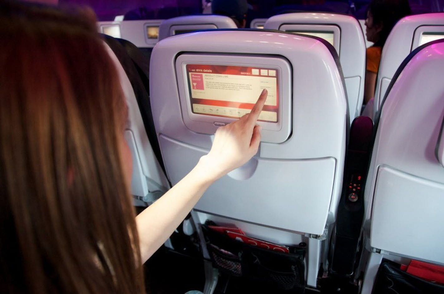 This product image provided by Virgin America Airlines shows a demonstration of the airline's in-flight on demand food and drink ordering system. Throughout the flight, passengers can order cookies, chicken sandwiches, margaritas and more on touchscreens in front of them.