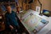 Keith Myrmel with his map of Itasca State Park at his home in Arden Hills. Myrmel, a former landscape architect, continues to produce maps of iconic M