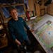 Keith Myrmel with his map of Itasca State Park at his home in Arden Hills. Myrmel, a former landscape architect, continues to produce maps of iconic M
