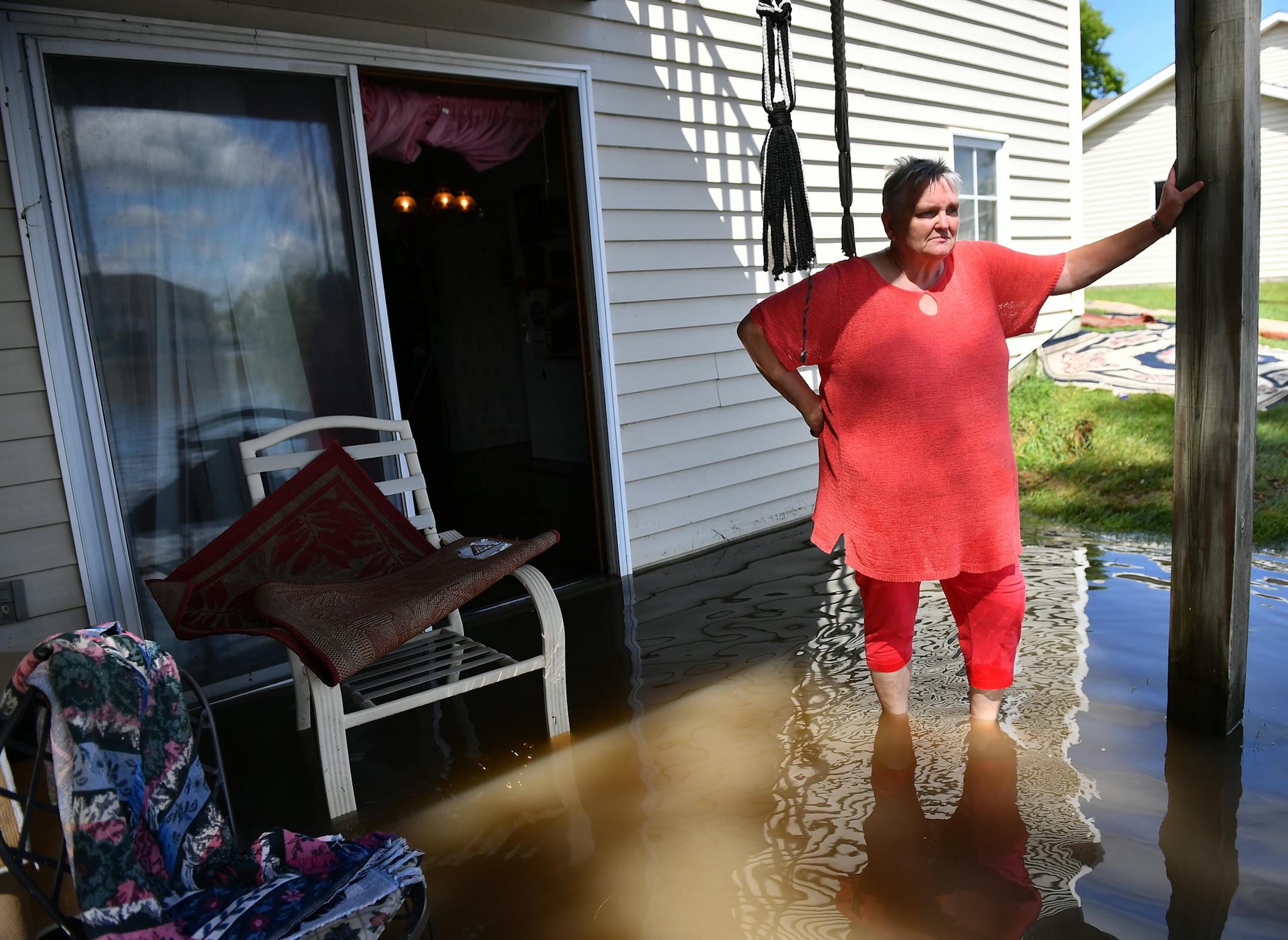 Kathy Petersen, of Willmar, stood outside her flooded apartment Thursday as she cleaned and surveyed the damage from last night's storm. "It's overflowed its banks a couple times but nothing like this" Petersen said of the pond near her apartment which flooded her unit and others in the area. ] (AARON LAVINSKY/STAR TRIBUNE) aaron.lavinsky@startribune.com Slow moving thunderstorms overnight dropped copious amounts of rain across central Minnesota and the Twin Cities, leading to flooding. And more