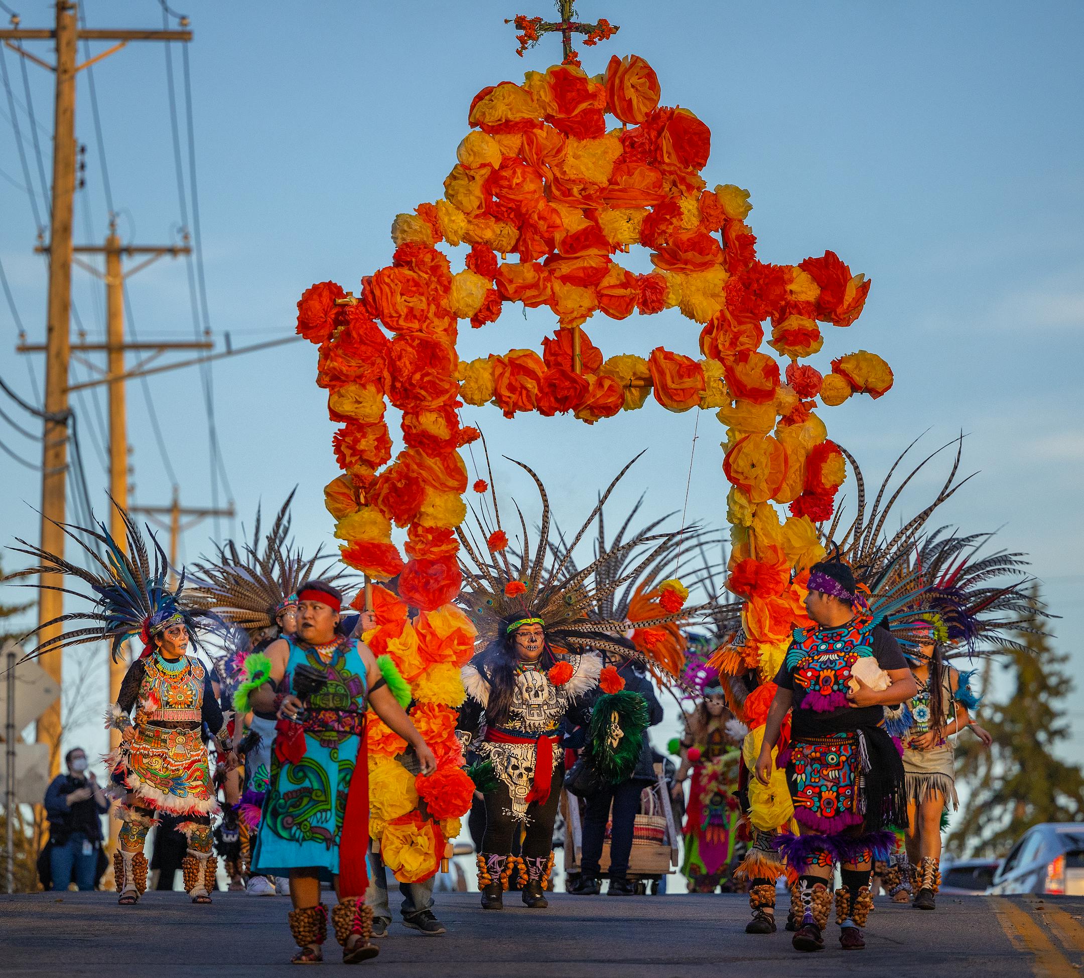 Members of the Kapuli KetzalCoatilcue dance company, lead a procession to begin the Dia De Los Muertos Celebration held at El Colegio High School.