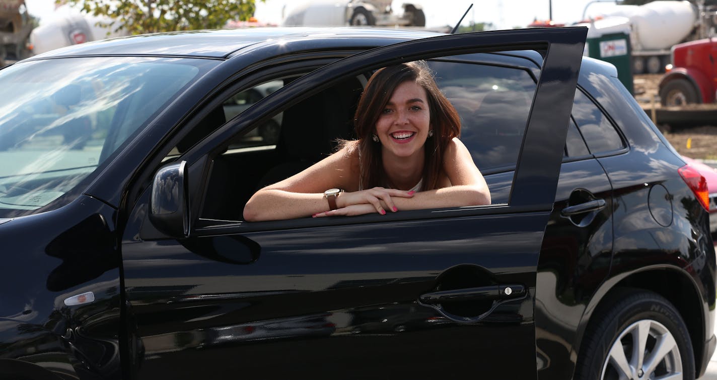 Courtney Anderson, of Minneapolis, showed off her brand new car, an Outlander Sport in front of the Richfield Bloomington Mitsubishi dealership. ] (KYNDELL HARKNESS/STAR TRIBUNE) kyndell.harkness@startribune.com At the Richfield Bloomington Mitsubishi and Honda dealership in Richfield Min. Wednesday, August, 13, 2014.