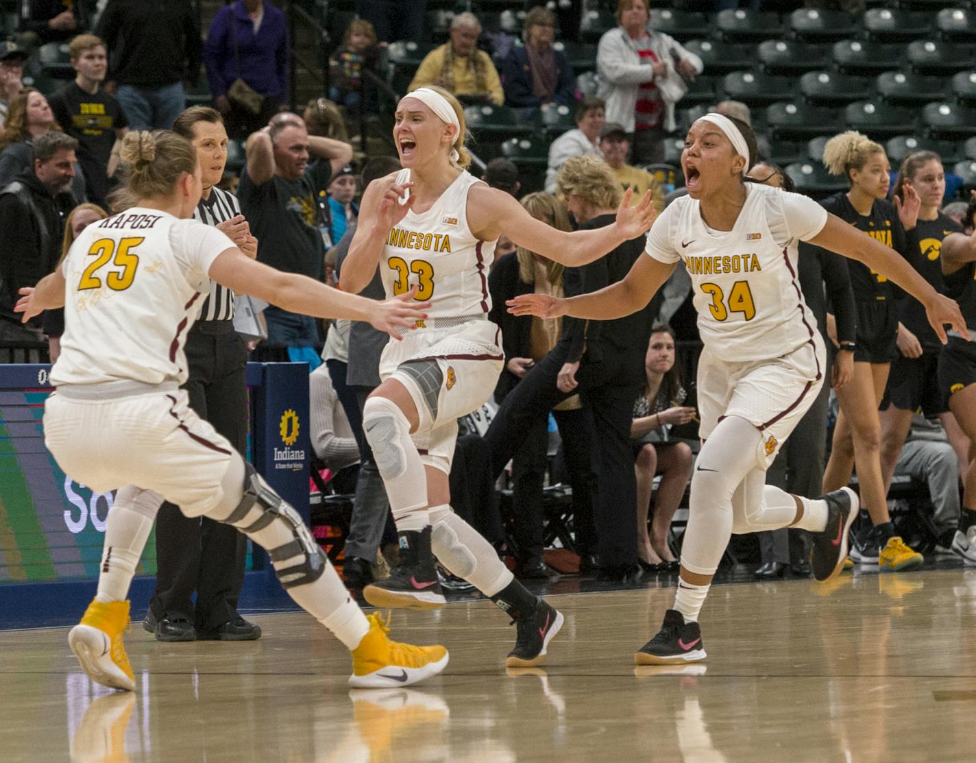 Minnesota Golden Gophers celebrate on the court after winning a quarter-final game in the 2018 NCAA Big Ten Womens' Basketball tournament at Bankers Life Fieldhouse in Indianapolis, Friday, March 2, 2018. Minnesota won 90-89.