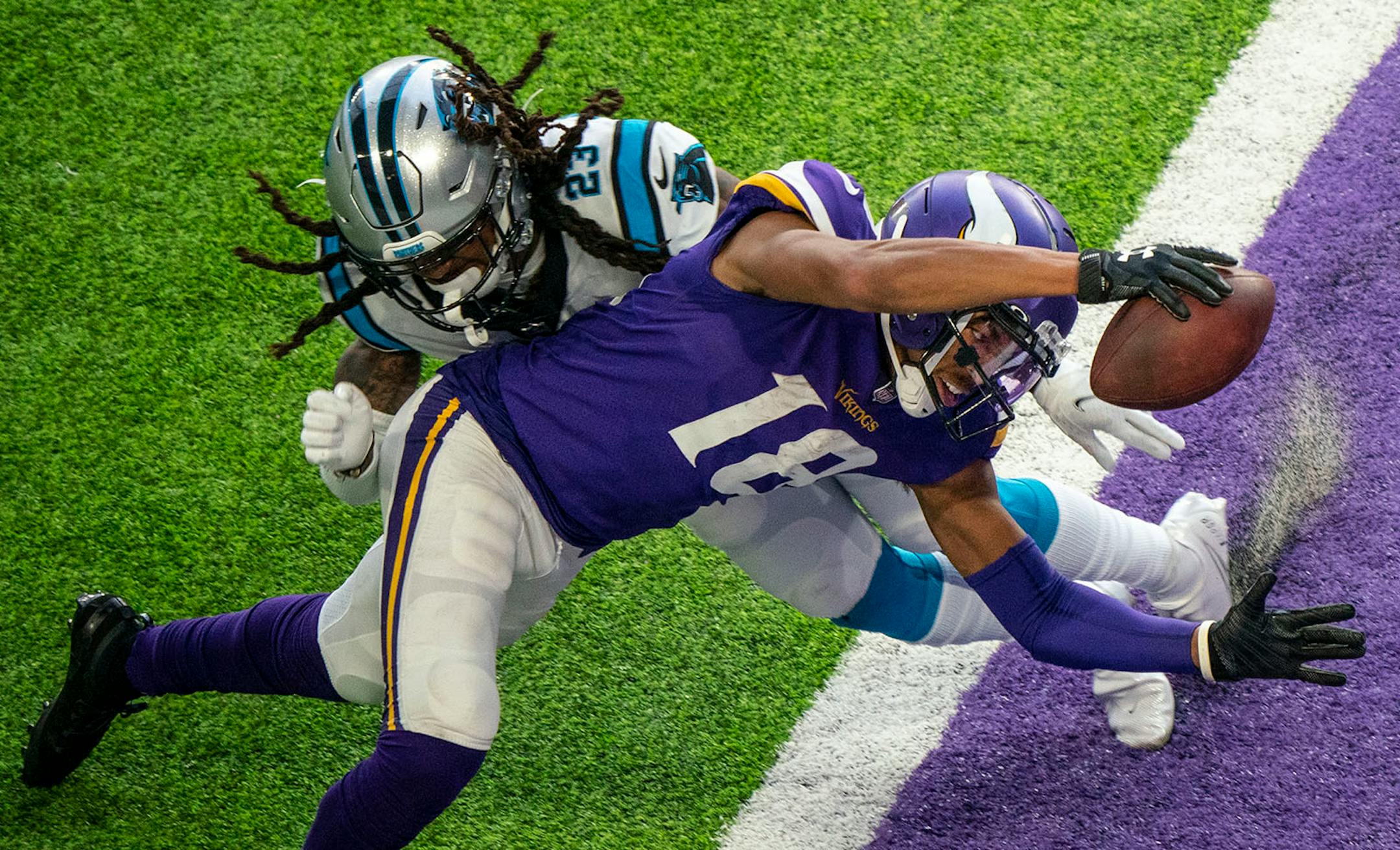 Minnesota Vikings wide receiver Justin Jefferson (18) dove past Carolina Panthers cornerback Stantley Thomas-Oliver (23) to score his second touchdown of the day in the fourth quarter on Sunday.